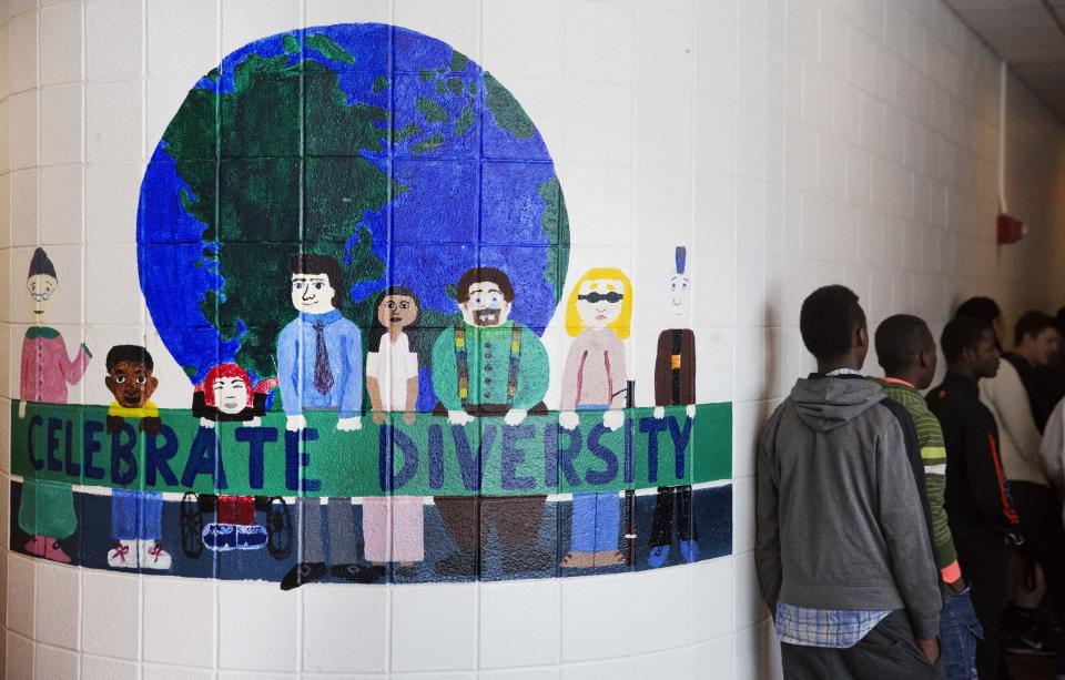 FILE - A mural celebrating diversity decorates a hallway in Lewiston High School in Lewiston, Maine, March 15, 2017. Seventy years after the Supreme Court's Brown v. Board, America is both more diverse — and more segregated. (AP Photo/David Goldman, File)