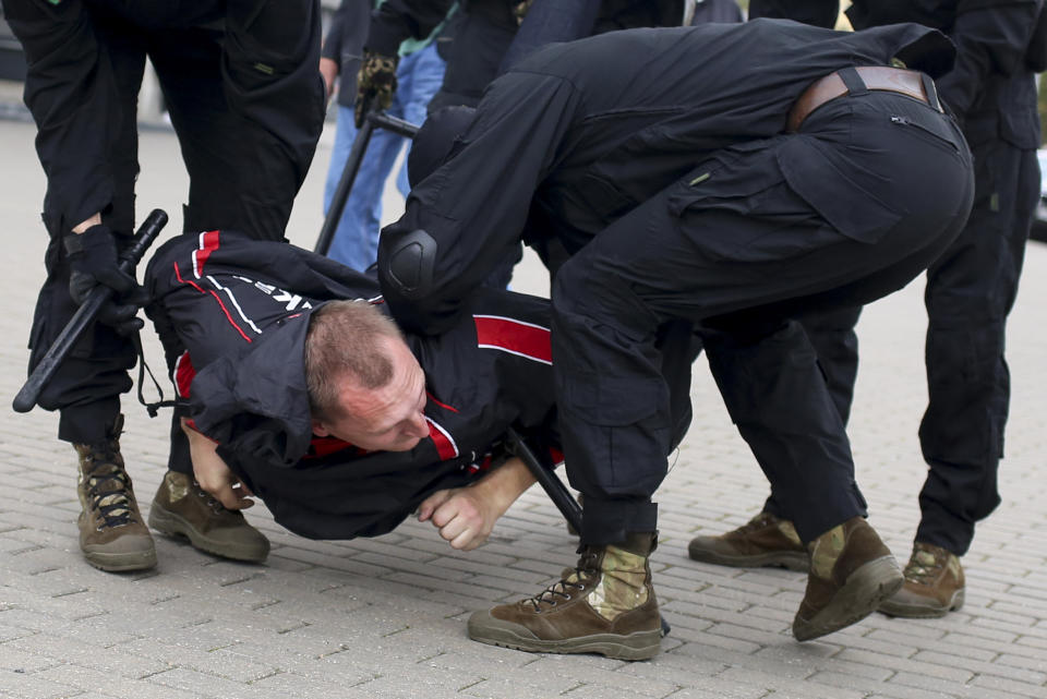 Police detain a demonstrator during an opposition rally to protest the official presidential election results in Minsk, Belarus, Sunday, Sept. 27, 2020. Hundreds of thousands of Belarusians have been protesting daily since the Aug. 9 presidential election. (AP Photo/TUT.by)