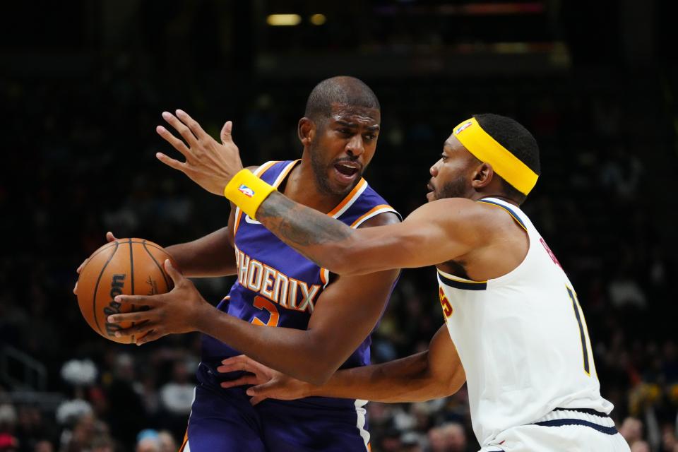 Oct 10, 2022; Denver, Colorado, USA; Phoenix Suns guard Chris Paul (3) and Denver Nuggets forward Bruce Brown (11) in the first quarter at Ball Arena.