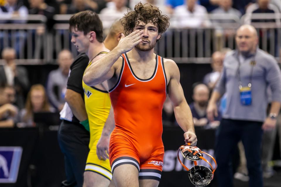 OSU's Daton Fix celebrates his victory over Michigan's Dylan Ragusin during the NCAA wrestling 133-pound semifinal on Friday.