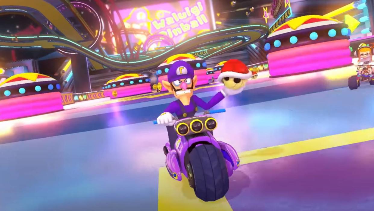  A screenshot of Waluigi racing on Waluigi Pinball in Mario Kart 8 Deluxe's Booster Course Pass. 