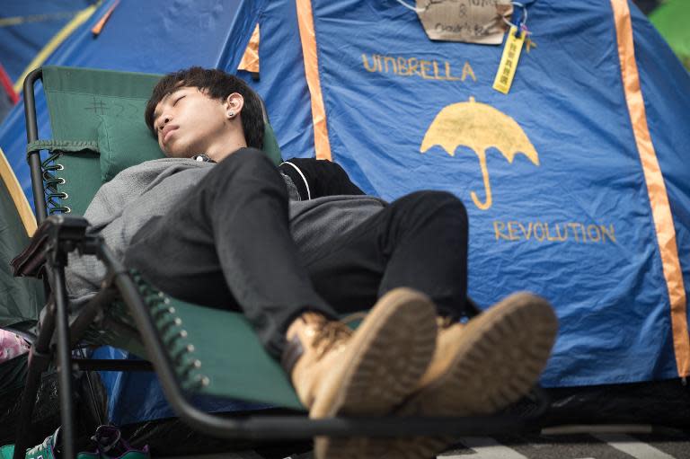 A pro-democracy protester sleeps at a camp site in the Admiralty district of Hong Kong on October 30, 2014