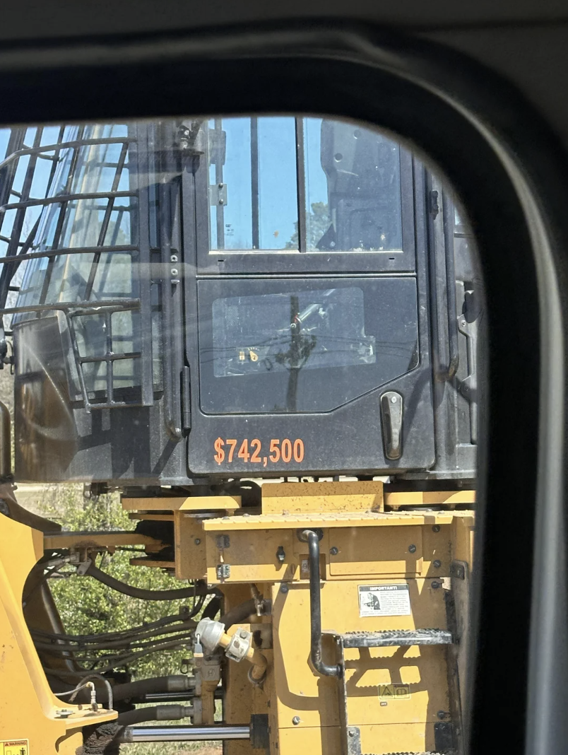 Price tag of $742,500 displayed on a construction vehicle's window