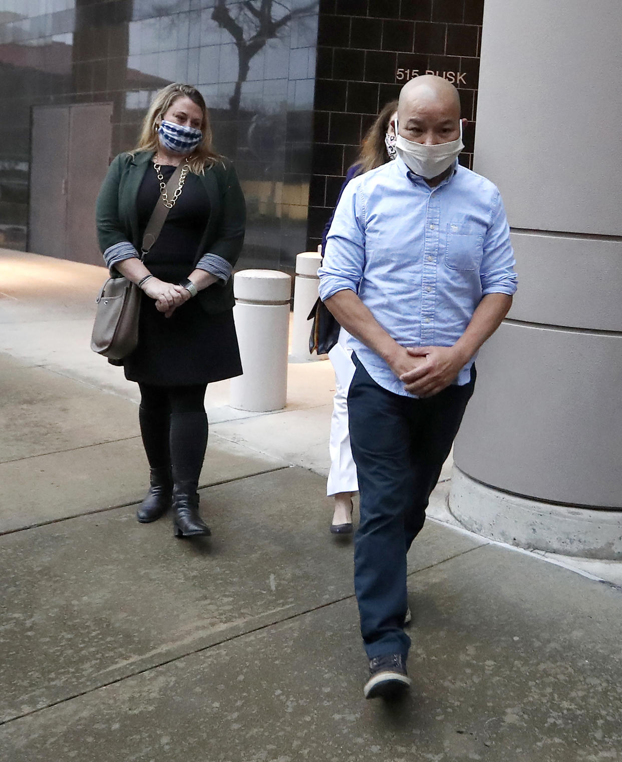 In this Jan. 21, 2021, photo former Houston Police Officer Tam Pham walks out of the Federal Courthouse downtown in Houston after he appeared in court following his arrest Wednesday on federal charges tied to Capitol violence. Police departments across the country are reviewing the behavior of dozens of officers who were in Washington on the day of a riot at the U.S. Capitol. (Karen Warren/Houston Chronicle via AP)