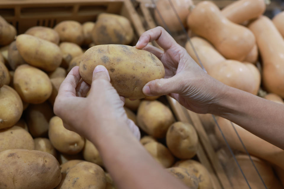 close up female consumer select potato ,vegetable and food shopping lifestyle