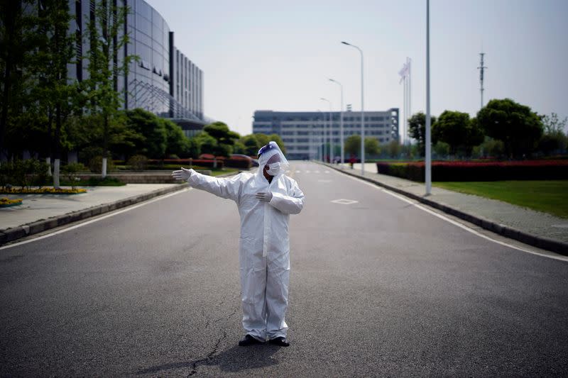 Worker in a protective suit is seen at a Dongfeng Honda factory in Wuhan