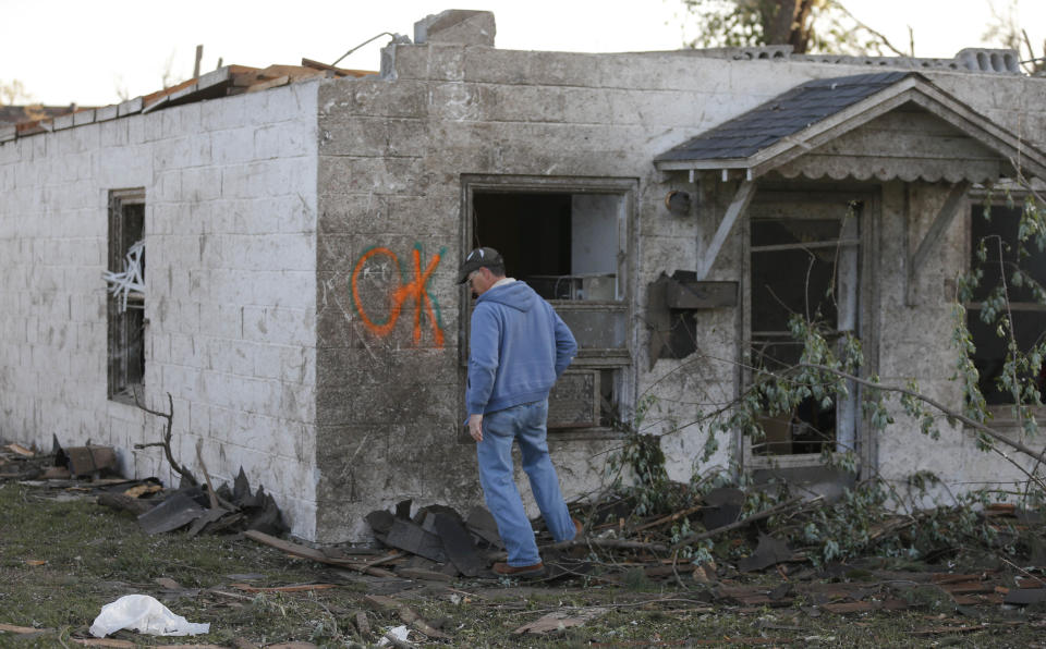 Bob Hessee checks out property owned by a friend and damaged by a tornado Sunday evening in Baxter Springs, Kan., Monday, April 28, 2014. The tornado left a trail of shattered homes, twisted metal and hanging power lines. One person died, but it was not clear whether the death was related to the storm. Volunteers were meeting early Monday to discuss cleanup efforts. Emergency officials say 60 to 70 homes and 20 to 25 businesses were destroyed or damaged in the town. (AP Photo/Orlin Wagner)