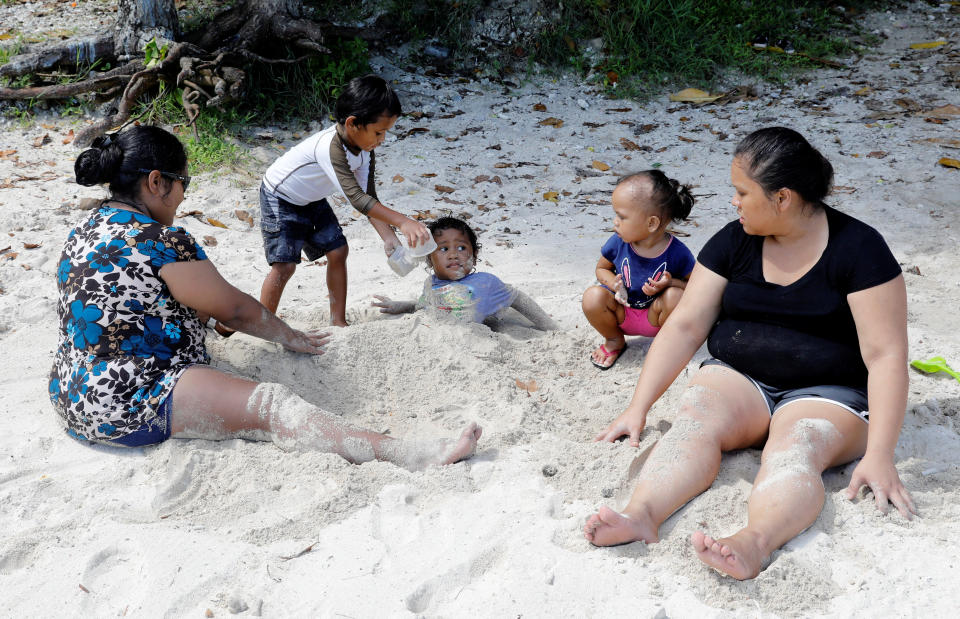 <p>Local residents are pictured at the Tumon beach on the island of Guam, a U.S. Pacific Territory, August 11, 2017. (Erik De Castro/Reuters) </p>