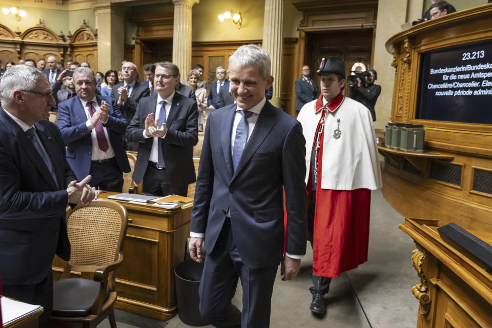 Newly elected Federal Councillor Beat Jans, follows his government colleagues into the chamber for the swearing-in ceremony following the Federal Council general election by the United Federal Assembly, in Bern, Switzerland, Wednesday, Dec. 13 2023. (Peter Schneider/Keystone via AP)