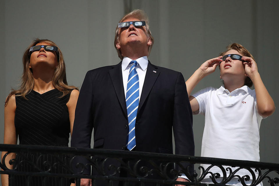 President Trump, Melania and Barron observe the solar eclipse of Aug. 21, 2017, with glasses. <cite>Mark Wilson/Getty</cite>