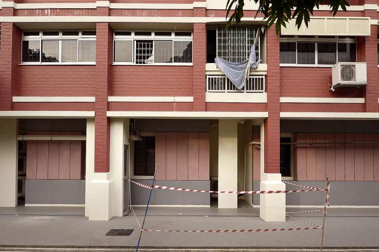 An area had to be cordoned off because of dangling blinds from the windows in Pasir Ris. Credit: The Straits Times