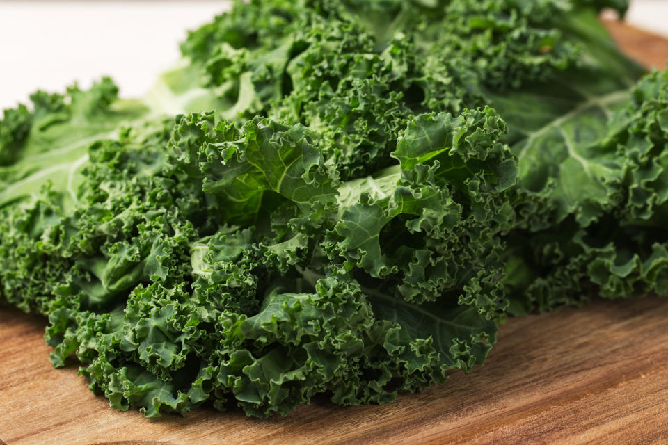 Fresh kale leaves on a wooden cutting board