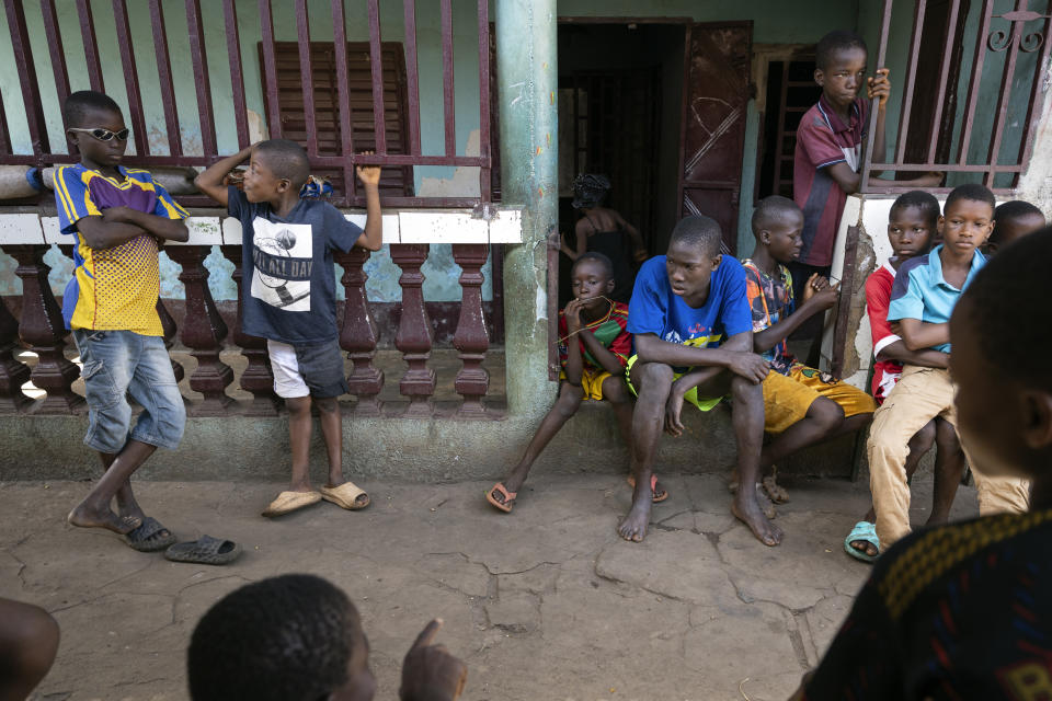 Children gather at the family home of the late Ousmane Sylla ahead of his body's arrival at Matoto Bonagui, a suburb of Conakry, Guinea, Monday, April 8, 2024. (AP Photo/Misper Apawu)