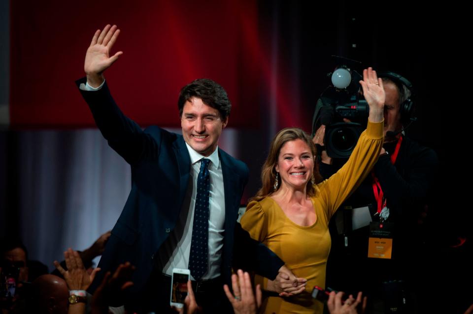 (FILES) In this file photo taken on October 21, 2019 Prime minister Justin Trudeau and his wife Sophie Grégoire Trudeau arrive to celebrates his victory with his supporters at the Palais des Congres in Montreal during Team Justin Trudeau 2019 election night event in Montreal, Canada. - Canadian Prime Minister Justin Trudeau and his wife announced they were self-isolating on March 12, 2020 as she undergoes tests for the new coronavirus after returning from a speaking engagement with "mild flu-like symptoms." Sophie Gregoire-Trudeau's symptoms have subsided since she recently got back from Britain, but as a precaution the prime minister "will spend the day in briefings, phone calls and virtual meetings from home," according to a statement. (Photo by Sebastien ST-JEAN / AFP) (Photo by SEBASTIEN ST-JEAN/AFP via Getty Images) ORIG FILE ID: AFP_1PU5PA
