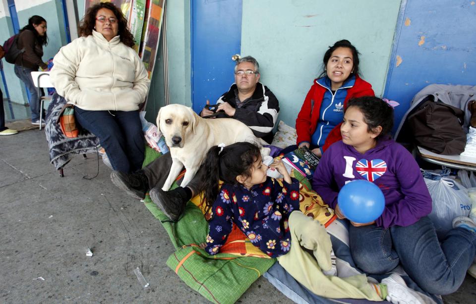 Residents gather in a shelter after a forest fire burned several neighbourhoods in the hills of Valparaiso city