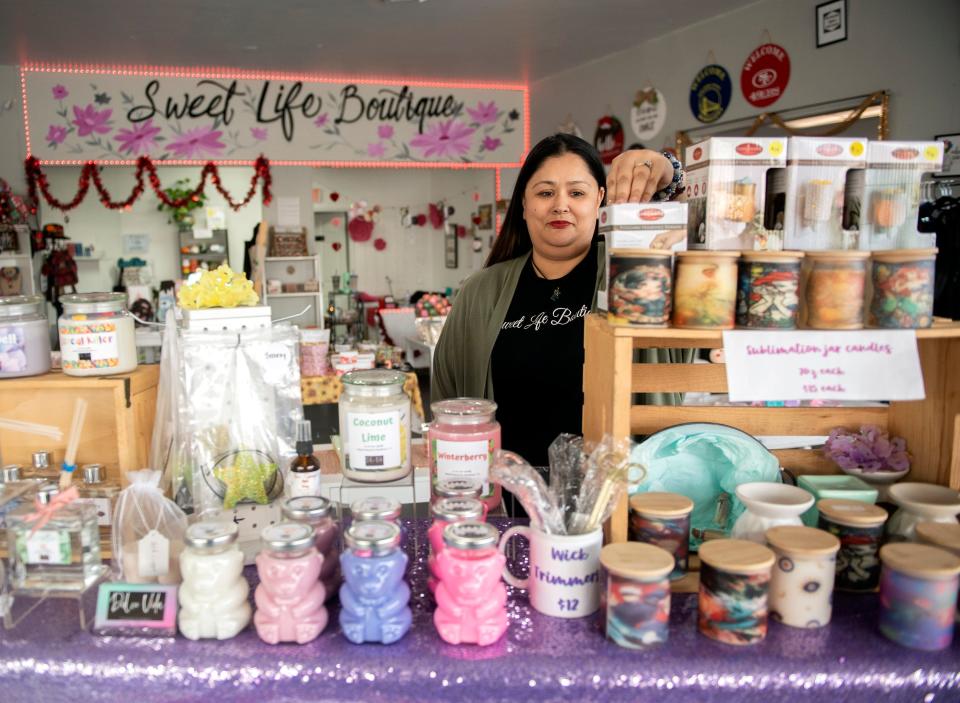 Sweet Life Boutique owner Juanita Pasley checks out merchandise at her store which hosts independent vendors on the Miracle Mile on Tuesday, Feb. 7, 2023.
