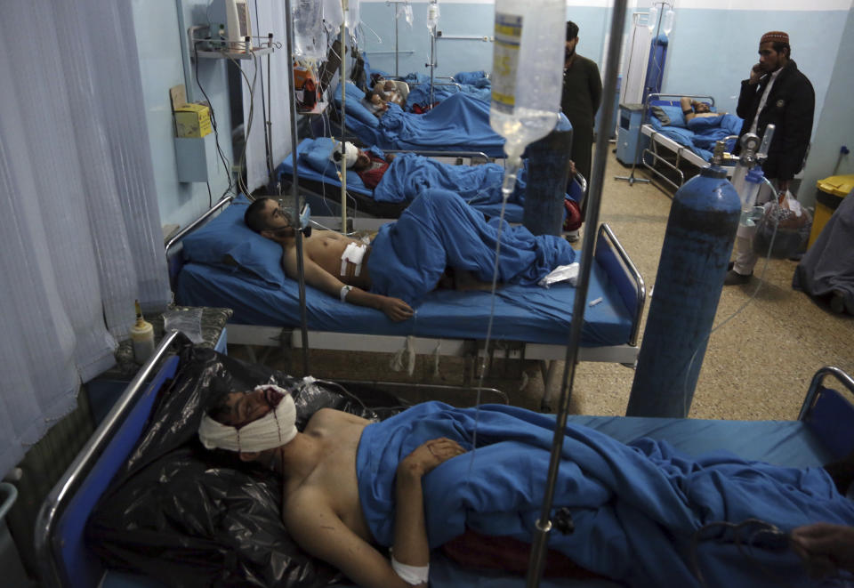 Injured men receive treatment at a hospital after a suicide bombing in Kabul, Afghanistan, Nov. 20, 2018. Afghan officials said the suicide bomber targeted a gathering of Muslim religious scholars in Kabul. (AP Photo/Rahmat Gul)