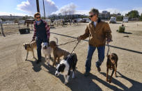 <p>Teresa Merritt, left helps her sister Mary Lou Miller with her dogs after being evacuated at The Pierce College Equine Center where evacuees are bringing their large and small animals in the Woodland Hills section of Los Angeles on Nov. 9, 2018. (Photo: Richard Vogel/AP) </p>