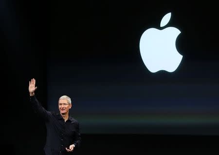 Apple CEO Tim Cook speaks during a presentation at Apple headquarters in Cupertino, California in this file photo from October 16, 2014. REUTERS/Robert Galbraith/Files