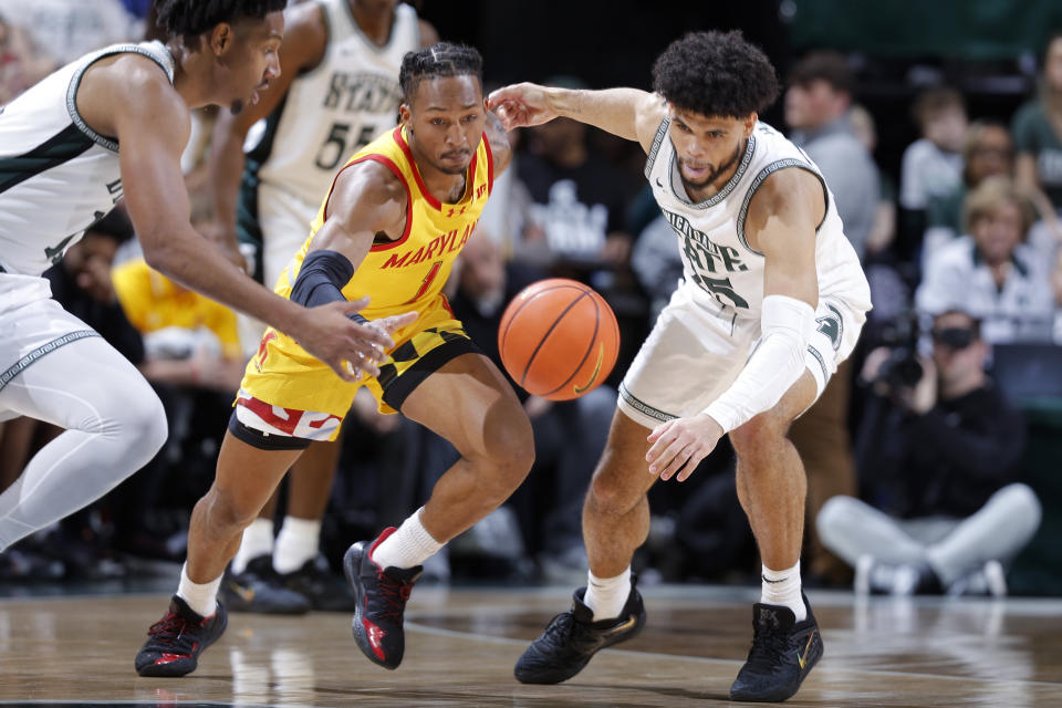 Michigan State forward Malik Hall, right, Michigan State guard A.J. Hoggard, left, and Maryland guard Jahmir Young, center, chase the ball during the first half of an NCAA college basketball game, Saturday, Feb. 3, 2024, in East Lansing, Mich. (AP Photo/Al Goldis)