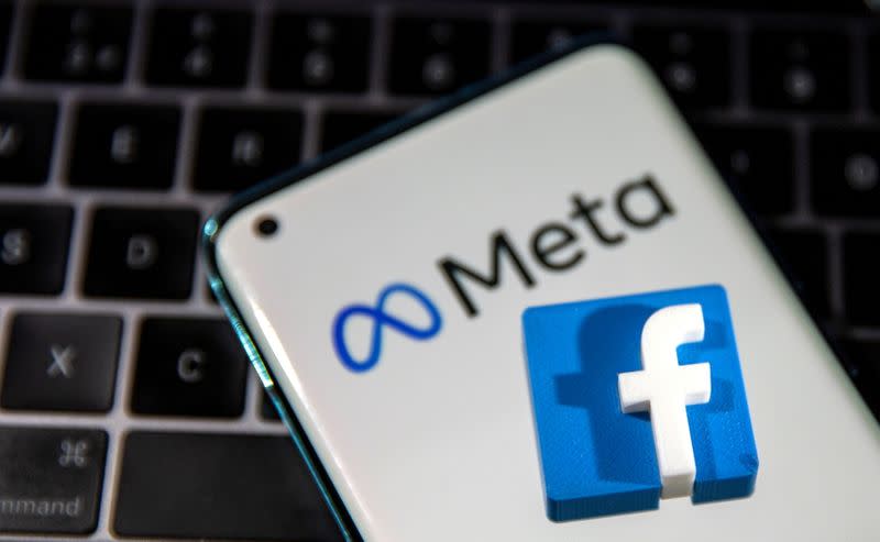 FILE PHOTO: A smartphone with Meta logo and a 3D printed Facebook logo is placed on a laptop keyboard in this illustration