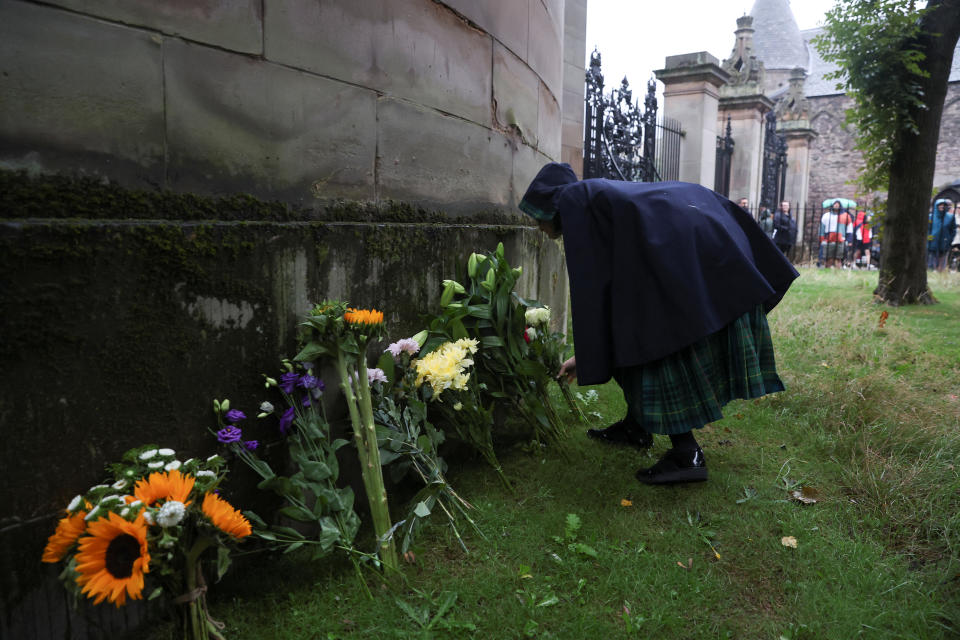 An announcement of the death of Queen Elizabeth is seen on a fence outside the Palace of Holyroodhouse