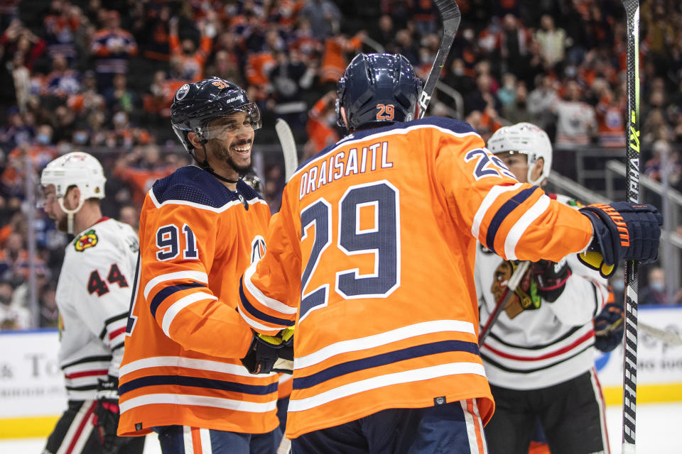 Edmonton Oilers' Evander Kane (91) and Leon Draisaitl (29) celebrate a goal against the Chicago Blackhawks during the second period of an NHL hockey game Wednesday, Feb. 9, 2022, in Edmonton, Alberta. (Jason Franson/The Canadian Press via AP)