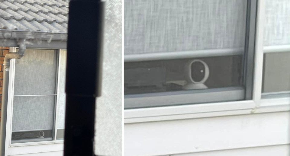 A security camera seen in a window facing the neighbour's house.
