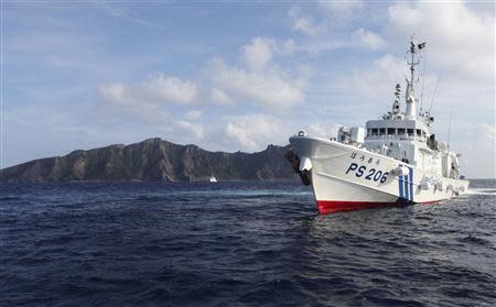 Japan Coast Guard vessel PS206 Houou sails in front of Uotsuri island, one of the disputed islands, called Senkaku in Japan and Diaoyu in China, in the East China Sea in this August 18, 2013 file photo. REUTERS/Ruairidh Villar/Files