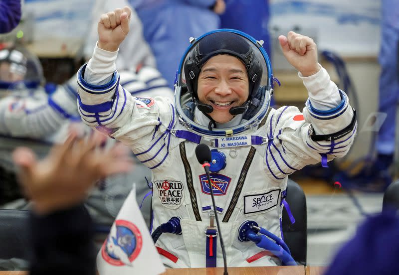 FILE PHOTO: Japanese entrepreneur Yusaku Maezawa reacts as he speaks with his family after donning space suits shortly before the launch to the International Space Station (ISS) at the Baikonur Cosmodrome