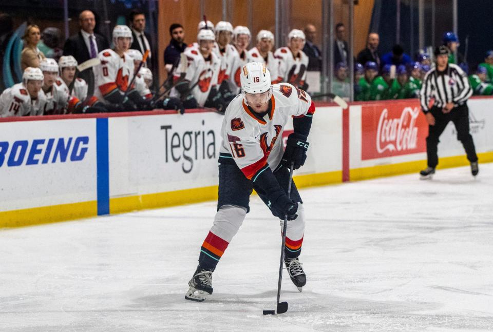 Firebirds forward Kole Lind (16) takes the puck down the ice during the second period of their game at Kraken Community Iceplex in Seattle, Wash., Friday, Oct. 21, 2022. 