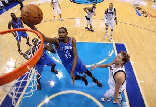 Kevin Durant of the Oklahoma City Thunder takes a shot against Dirk Nowitzki of the Dallas Mavericks during Game Four of the Western Conference Quarterfinals in the 2012 NBA Playoffs, at American Airlines Center, on May 5, in Dallas, Texas. Mavs were swept out of the playoffs as the Thunder wrapped up their West Conference series with a 103-97 victory