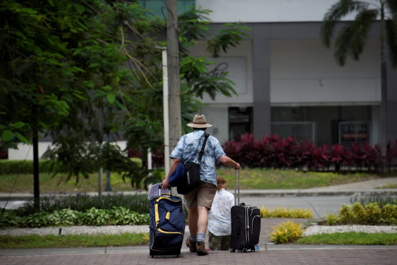 FILE PHOTO: European tourists try to reach the airport as the spread of the coronavirus disease (COVID-19) continues in Guayaquil