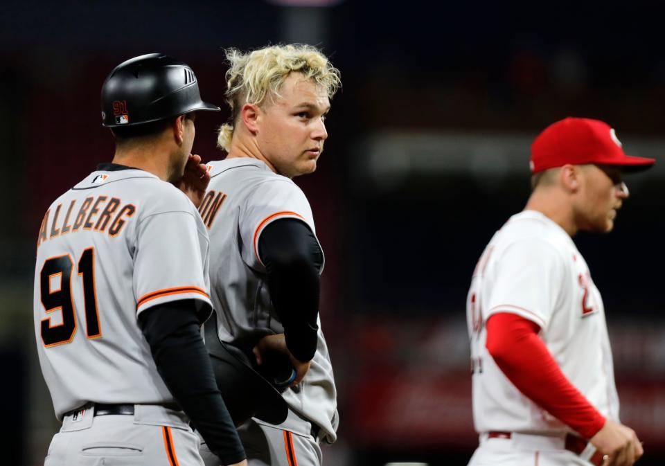 May 27, 2022; Cincinnati, Ohio, USA; San Francisco Giants left fielder Joc Pederson (middle) stands at third base with San Francisco Giants third base coach Mark Hallberg (91) during the second inning against the Cincinnati Reds at Great American Ball Park. Mandatory Credit: David Kohl-USA TODAY Sports