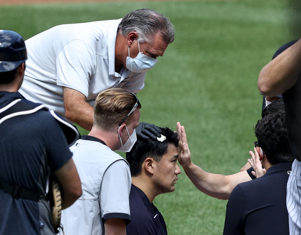 NEW YORK, NEW YORK - JULY 04:  Masahiro Tanaka #19 of the New York Yankees is checked after he was hit by a batted ball during summer workouts at Yankee Stadium on July 04, 2020 in the Bronx borough of New York City. (Photo by Elsa/Getty Images)