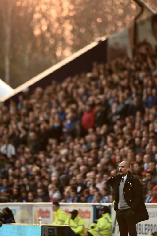 Manchester City's manager Pep Guardiola watches from the touchline during their English FA Cup fifth round football match against Huddersfield Town in Huddersfield, northern England on February 18, 2017