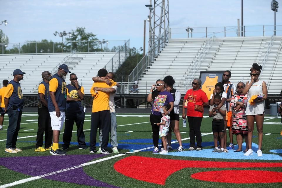 The Southeast boys track and field team embraced Keyon Day's family at Memorial Stadium during the City boys and girls track and field meet on Tuesday, April 30, 2024.