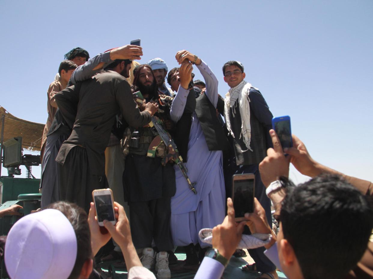 Taliban militants meets Afghan people during a visit to Ghazni on the on second day of a three-day ceasefire to mark Eid al-Fitr: EPA
