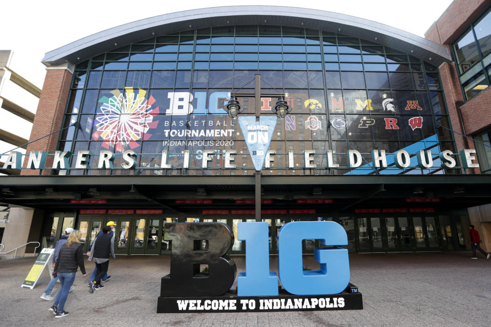 UPDATES TOURNAMENT CANCELLED - Fans enter The Bankers Life Fieldhouse for a game at the Big Ten Conference tournament in Indianapolis, Thursday, March 12, 2020. The Big Ten Conference announced that remainder of the men's NCAA college basketball games tournament was cancelled. (AP Photo/Michael Conroy)