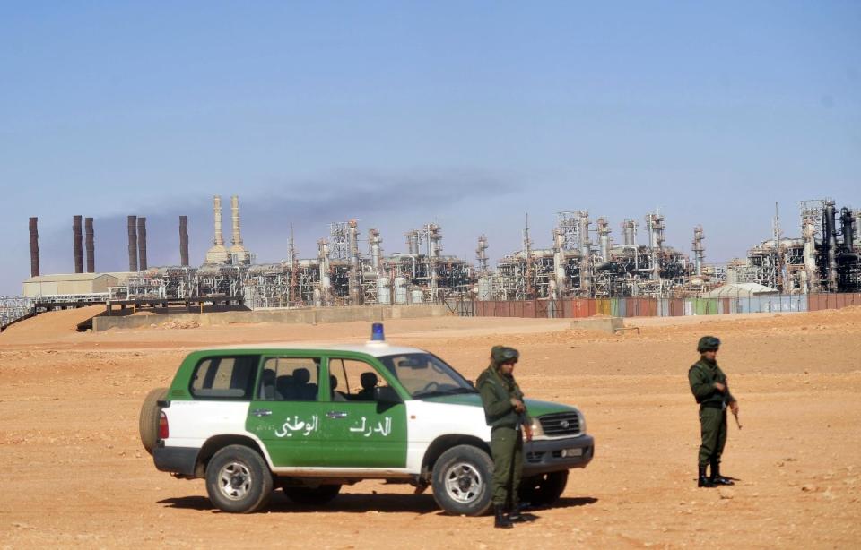 FILE - In this Jan. 31, 2013 file photo, Algerian soldiers stand guard during a visit for news media organized by the Algerian authorities at the gas plant in Ain Amenas, seen in background. In Algeria, which has been run by a succession of military men for decades, presidential elections often are foregone conclusion. But not this year. The campaign for the April vote already is raising questions: Will the ailing president run for re-election? If not, will his supporters and the powerful intelligence services be able to agree on someone else? And where does Algeria’s army stand in all this? With the lack of any clear direction from on top, political squabbles are being fought in the media, with the head of the governing party decrying the shadowy intelligence chief’s grip on power, and a journalist accusing the president’s brother of corruption and scandalous personal behavior. (AP Photo, File)