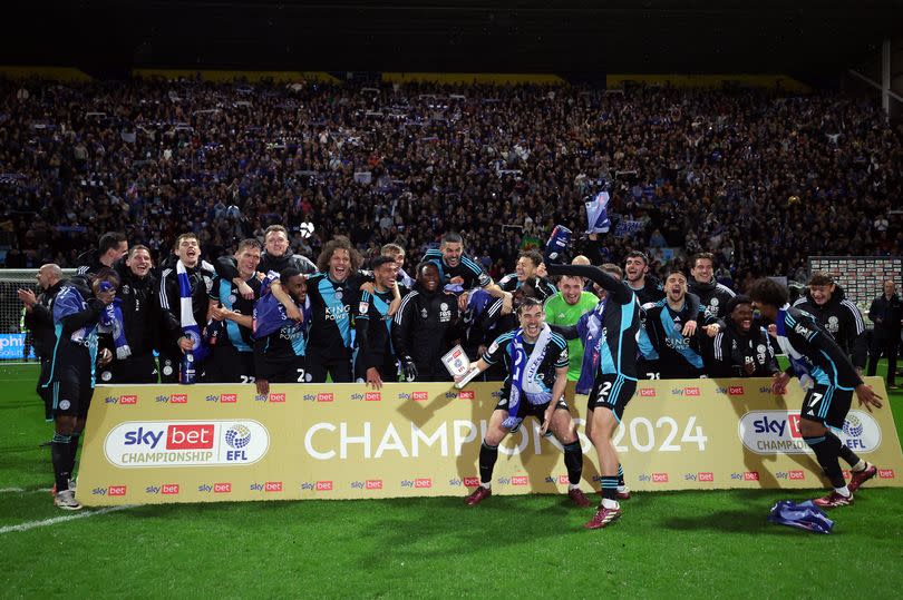 The players of Leicester City celebrate at full-time following the team's victory to win the title