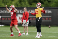 Kansas City Chiefs quarterback Patrick Mahomes (15) and tight end Travis Kelce warm up before the NFL football team's organized team activities Thursday, May 26, 2022, in Kansas City, Mo. (AP Photo/Charlie Riedel)