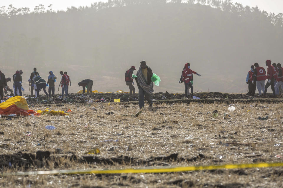 Rescuers work at the scene of an Ethiopian Airlines flight crash near Bishoftu, or Debre Zeit, south of Addis Ababa, Ethiopia, Monday, March 11, 2019. A spokesman says Ethiopian Airlines has grounded all its Boeing 737 Max 8 aircraft as a safety precaution, following the crash of one of its planes in which 157 people were killed. (AP Photo/Mulugeta Ayene)