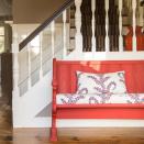 <p> This farmhouse hallway has been given a pop of brightening color with a coral bench and multicolored cushions. </p> <p> 'Your entryway serves as the introduction to your home and the wonderful characters that reside within,' says Mary Maloney, owner and designer at Bees Knees Interior Design Studio.  </p> <p> 'Your entry should suit the architecture of your home, along with the functional needs. The church pew in this entry holds sentimental value, along with a bit of family history, all of which suits this reproduction style colonial perfectly.  </p> <p> 'Details count: the bright color and fabric add to the charm and welcome all who enter!' </p>