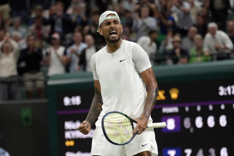 Australia's Nick Kyrgios celebrates beating Greece's Stefanos Tsitsipas during their third round men's singles match on day six of the Wimbledon tennis championships in London, Saturday, July 2, 2022. (AP Photo/Kirsty Wigglesworth)