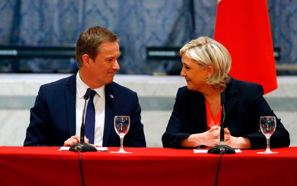 Nicolas Dupont-Aignan and Marine Le Pen during a joint statement at FN headquarters in Paris - Credit: AFP