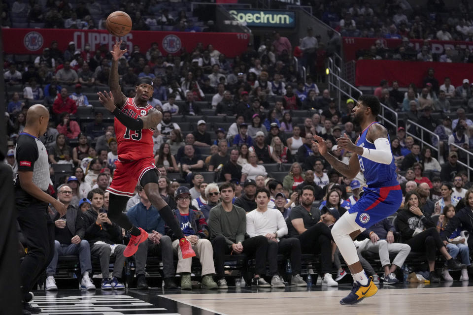 Chicago Bulls forward Torrey Craig, second from left, saves the ball going out of bounds as Los Angeles Clippers forward Paul George, right, watches during the first half of an NBA basketball game in Los Angeles, Saturday, March 9, 2024. (AP Photo/Eric Thayer)