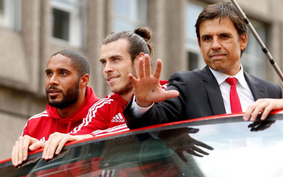 Wales' Gareth Bale (centre) and Ashley Williams (left) with manager Chris Coleman (right) acknowledge the fans on a open top bus during the homecoming in Cardiff City centr - PA Wire/Paul Harding