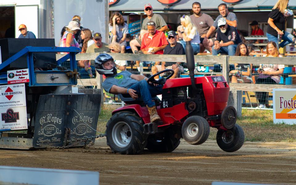 Ethan Ferry leans into the tractor pull at the Westport Fair on Saturday, July 16, 2022.