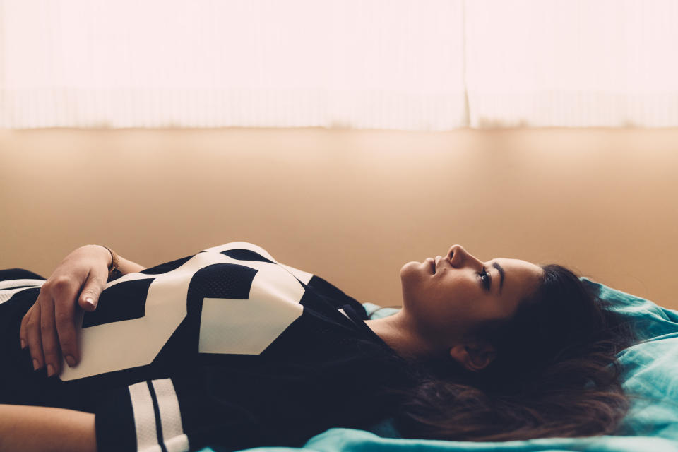 Woman lying down with her hand on her stomach